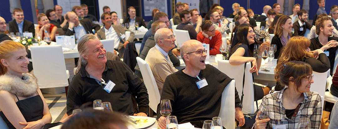 Charlie Caper performing close-up magic for a corporate audience